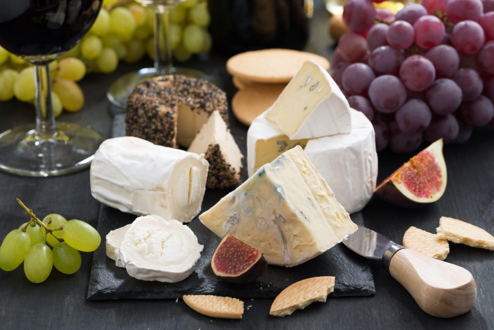 delicacy soft cheeses, fruit and crackers, close-up